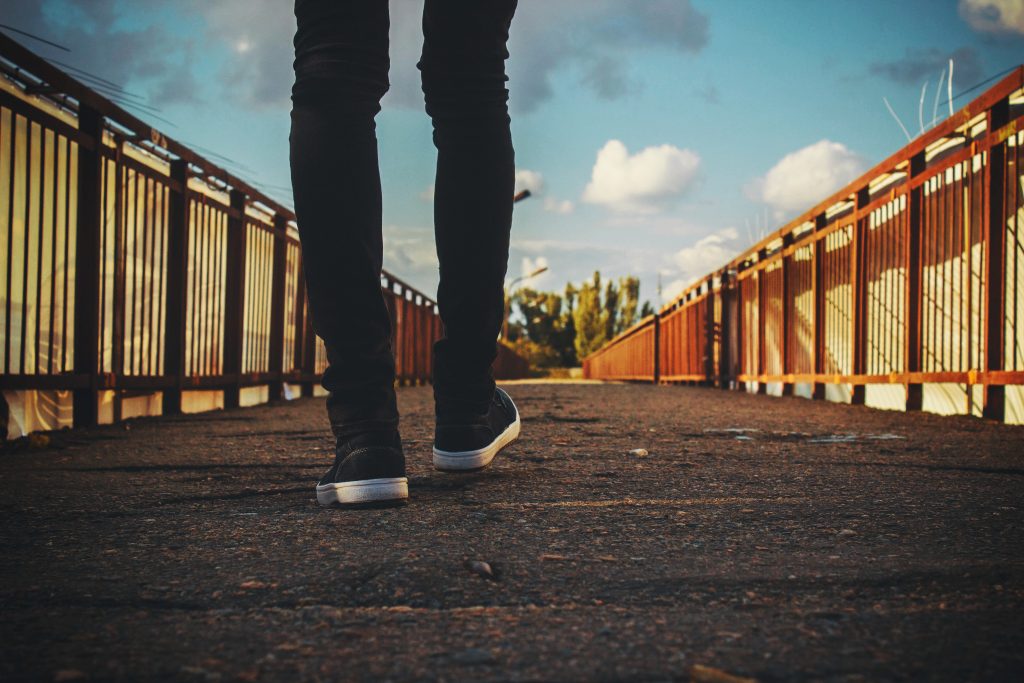 man walking on bridge