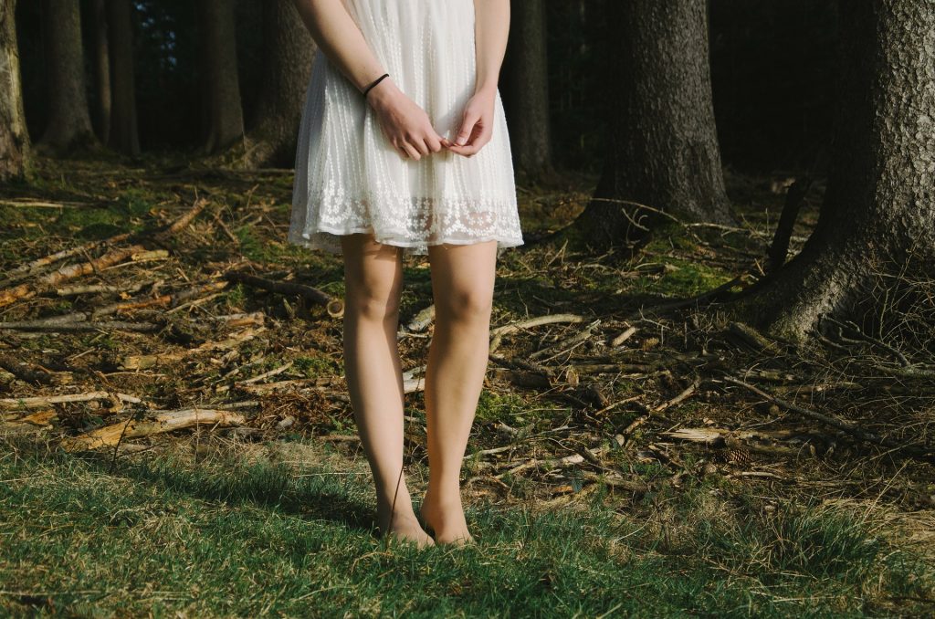 girl standing in the woods