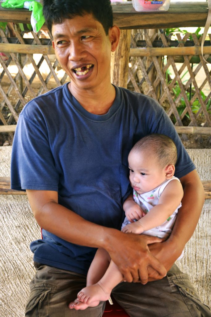 Rene, the House Dad in Home 4 at Village of Hope holds Jacob, the orphanage’s youngest child