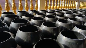 Men and women held silver bowls filled with water and flowers.