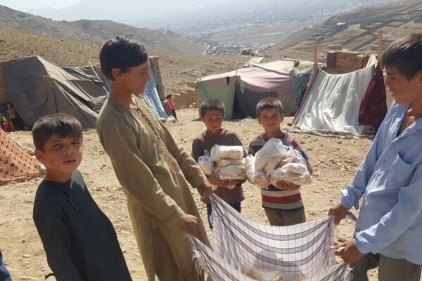 boys receive food at afghan camp