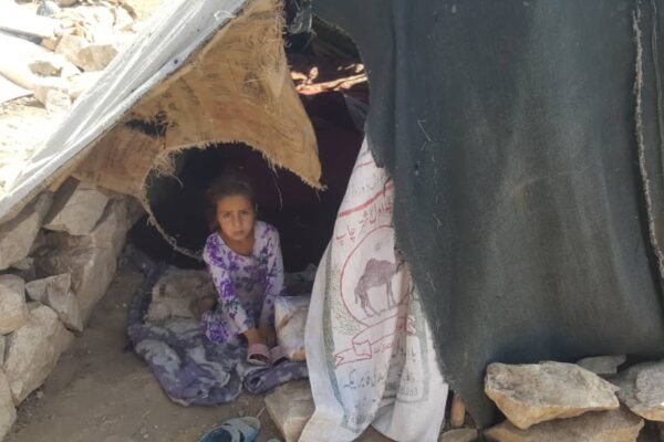 girl in a tent at Afghan camp